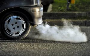 close up of car's fumes emissions in the traffic jam