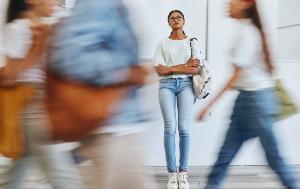 Youth walking on the street. One person standing