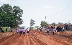 People walking in a road in the countryside of Uganda