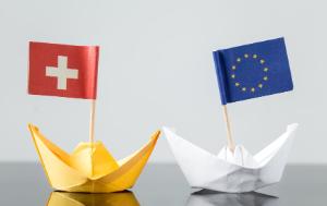 Paper boats with Switzerland and EU flag